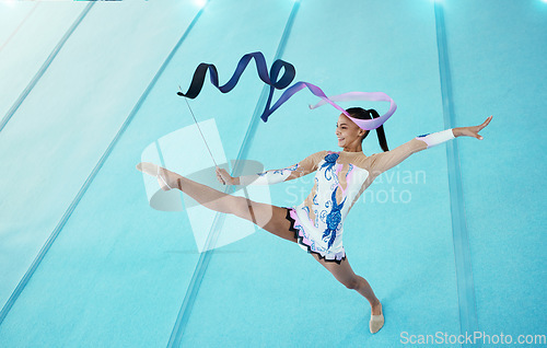 Image of Gymnastics, woman with ribbon for dance and sport performance, flexibility with professional athlete in gym and top view. Rhythmic gymnast, leg in air with fitness, grace and action with dancing