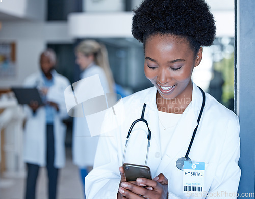 Image of Black woman, doctor and smile with phone in hospital on telehealth app, internet search and connection. Happy medical worker typing on smartphone technology for contact, reading online chat or clinic