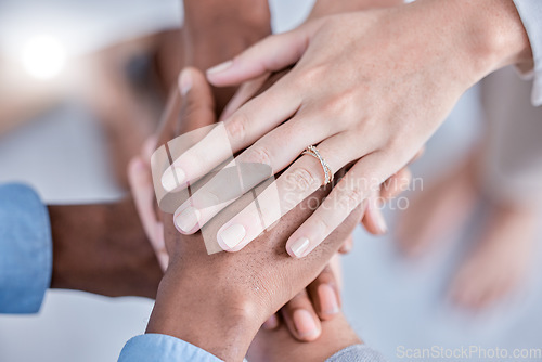 Image of Business people, diversity and hands together above in trust, partnership or collaboration at the office. Group of diverse employee workers piling hand in teamwork, support or agreement in solidarity