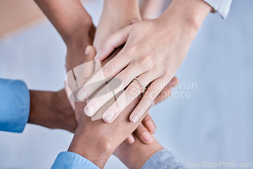 Image of Business people, diversity and hands together above in trust, partnership or collaboration at the office. Group of diverse employee workers piling hand in teamwork, support or agreement in solidarity