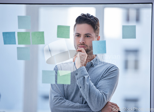 Image of Creative man, thinking and brainstorming in schedule planning glass board for tasks or reminder at office. Male wondering in thought for project plan, idea or sticky note strategy for company startup