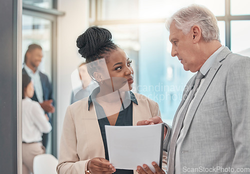 Image of Documents, discussion and man and black woman talking in office for business proposal, strategy or advice. Collaboration, teamwork and corporate managers meeting for project, report or finance review