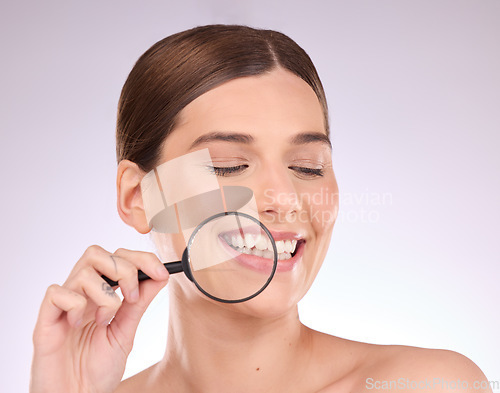 Image of Magnifying glass, teeth or woman with dental, smile or natural face beauty in oral health hygiene routine. Search, tooth or happy girl model with lens for wellness, clean mouth or treatment in studio
