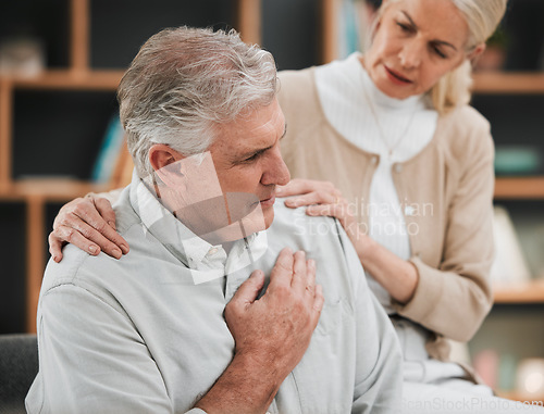 Image of Heart attack, pain and senior couple at home with cardiology problem or stroke. House, cardiac arrest and retirement of a man with emergency and health issue in a living room with female support