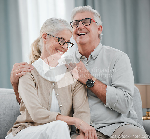 Image of Laughing, love or funny old couple hugging on house living room sofa together enjoying quality time. Smile, peace or happy mature man bonding with a supportive senior woman in retirement at home