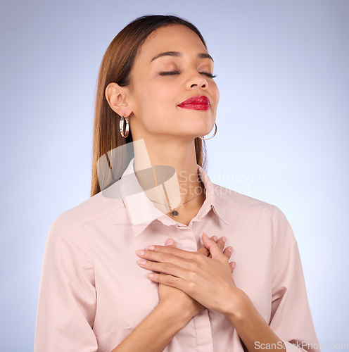 Image of Hands on chest, heart and self love with woman against studio background, content and with gratitude for health. Wellness, young female and calm with eyes closed, inner peace and zen with mindfulness