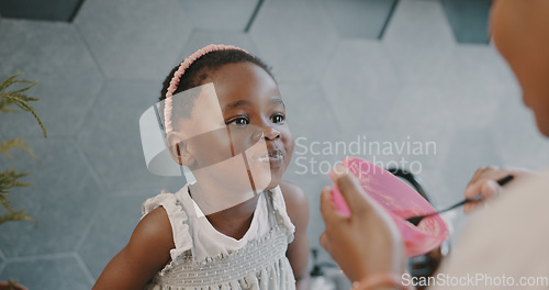 Image of Mother, child and breakfast with mom feeding girl food for nutrition, growth health and wellness in home kitchen. Black woman with girl at family house for quality time, love and eating healthy