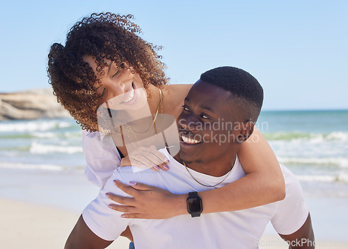 Image of Black couple, hug and smile for piggyback at the beach in summer vacation, bonding or embracing romance. Happy African American man giving woman back ride smiling for love, travel and holiday at sea