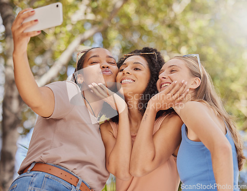 Image of Selfie, girl friends kiss and bonding of students together with travel and freedom. Outdoor, happiness smile and happy summer vacation taking social media profile picture in a park on holiday