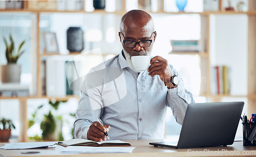 Image of Business, black man and drinking coffee while writing in notebook, schedule and strategy at office desk. Mature entrepreneur planning notes, information and journal of planner, agenda and reminder