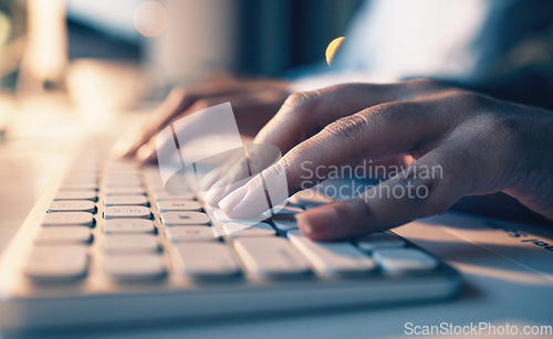 Image of Typing, computer and night with hands of person in office for email, overtime and project proposal. Technology, internet and search with employee and keyboard for report, deadline and planning