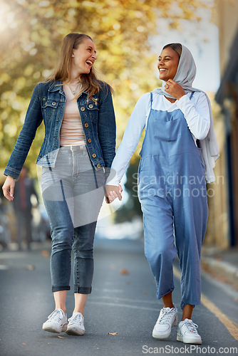 Image of Friends, diversity and holding hands with women in road for support, spring and travel together. Community, happy and smile with girls walking in street path for muslim, social and solidarity