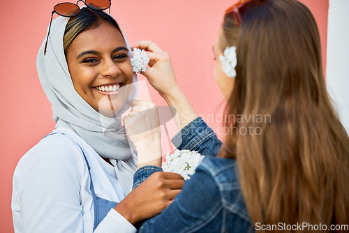 Image of Women, muslim and friends portrait with flower decoration, spring celebration or bonding in city. Young student, gen z girl and islam with smile, happiness and fashion for urban adventure for support