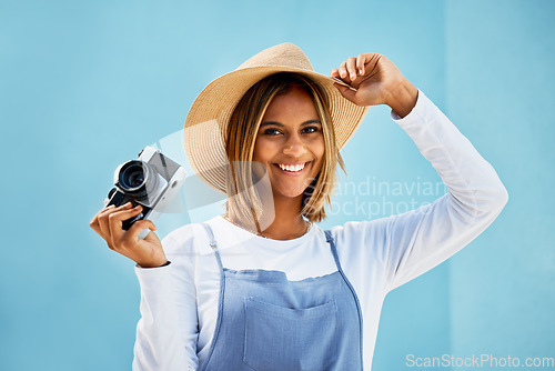 Image of Happy, camera and photographer with portrait of woman for creative, retro and shooting photos. Fashion, happiness and vintage with girl and photography for picture, lens and blue wall background