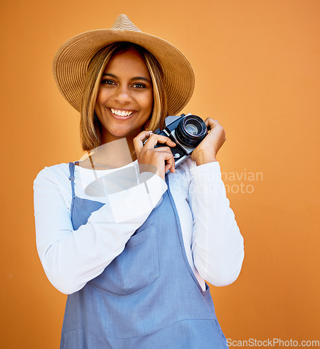 Image of Smile, camera and photographer with portrait of woman for creative, retro and shooting photos. Fashion, happiness and vintage with girl and photography for picture, lens and focus in wall background