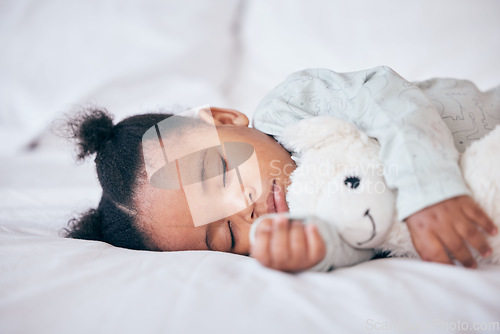 Image of Black child, baby and sleeping with toy in bedroom, home and nursery for peace, calm nap and dreaming. Tired young girl kid asleep with teddy bear for resting, break and healthy childhood development