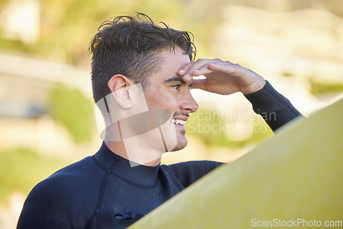 Image of Surfer man, beach and looking with smile for waves, excited and hand by eyes for safety in morning sunshine. Ocean athlete, surfboard or focus for fitness, sports and tropical adventure for workout