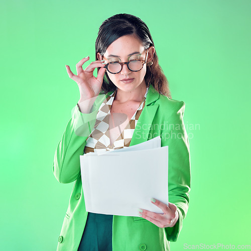 Image of Woman in glasses reading paper isolated on green background for fashion design career, gen z resume and internship. Young person or model with retro clothes and documents review for job opportunity