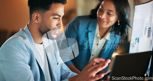 Image of Man, woman and tablet in office at night for analytics, research and information technology with teamwork. Businessman, web design discussion and mobile touchscreen at pc, data analysis and mentor