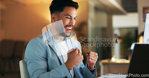 Image of Happy businessman, laptop and celebration for winning, deal or promotion at the office desk. Excited male celebrating victory, win or bonus for sales achievement working on computer at the workplace