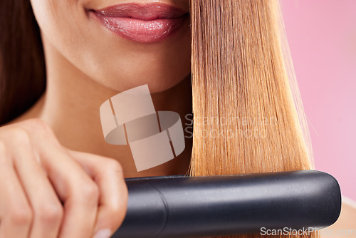 Image of Closeup, woman and hair straightener for care, texture and beauty against a studio background. Zoom, female and girl with salon tool, treatment and grooming for confidence, aesthetic and cosmetics