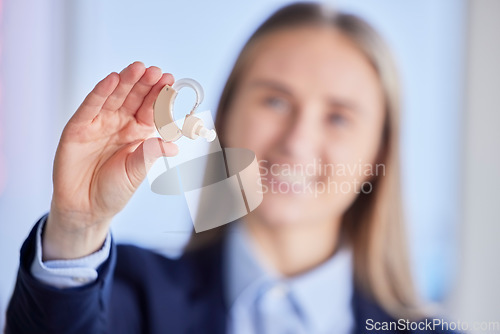 Image of Hands, hearing aid and deaf business woman with listening device for healthcare, wellness and disability. Closeup of audiology plug for female worker, professional and ears with communication sound