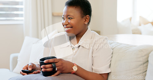 Image of Black woman, coffee and relax watching tv on sofa drinking espresso in living room home. Tea, happy smile and female from Nigeria streaming movie or online video on television and spending time alone
