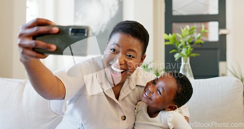 Image of Smartphone, selfie and mother with child on living room sofa for social media post, parents blog update or family home celebration. Black family smile in cellphone portrait photography for online app