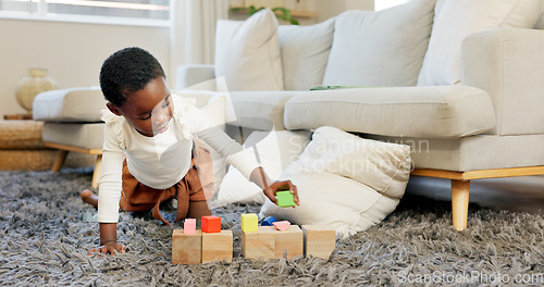 Image of Black girl, building blocks and creative learning in family home lounge, growth and fun development. Happy african kids, educational brick toys and wood puzzle, montessori play and living room game