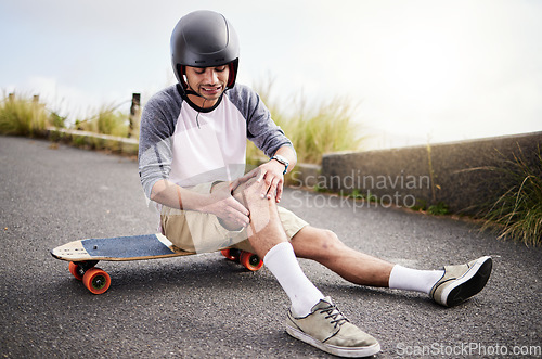 Image of Injury, man and knee pain after skateboarding fall, sports practice and learning to skate. Active, bad and skateboarder with a sprain, broken bone or holding a painful leg in the street while skating