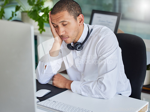 Image of Burnout, call center or tired agent sleeping at desk from overworked by deadlines or stress. Customer support, black man or lazy telemarketing consultant at computer exhausted, fatigue or resting