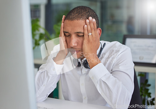 Image of Stress, anxiety or black man in call center with burnout or migraine pain at customer services help desk. Tired, headache or sick sales consultant frustrated with mistakes in a telemarketing company