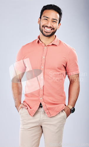 Image of Fashion, happy and portrait of a man in a studio with a casual, trendy and cool outfit. Happiness, smile and full length of a male model from Puerto Rico with style posing by a gray background.