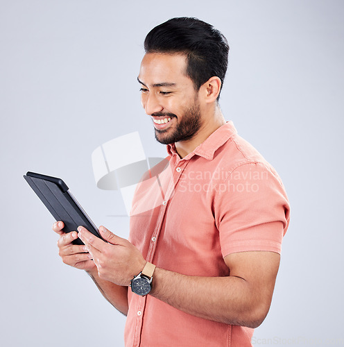 Image of Asian man, tablet or browsing on isolated studio background on internet sales, promotion or ecommerce store deals. Smile, happy or relax customer on technology, retail e commerce or online shopping