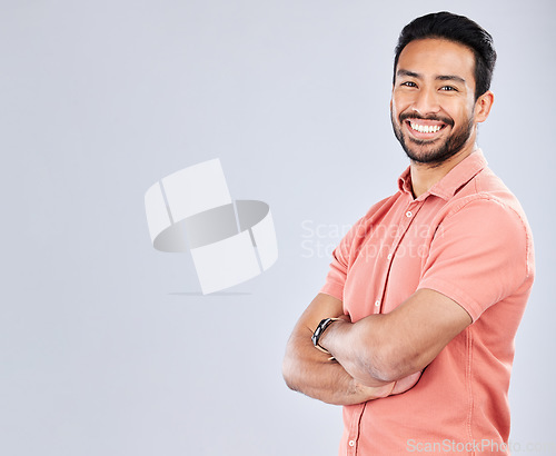 Image of Portrait, mock up and a man in studio, crossed arms standing on a gray background for branding or product placement. Marketing, advertising and mockup with a handsome young male posing on blank space