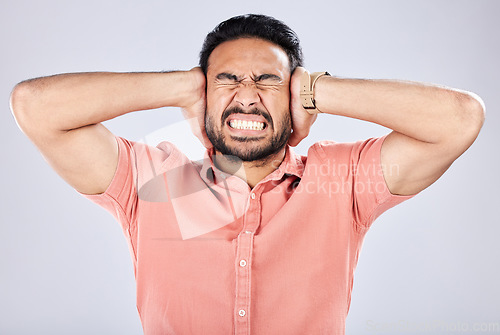 Image of Psychosis, mental health and angry Asian man with bipolar isolated on a grey studio background. Stress, fear and scared guy closing ears for noise, frustration and suffering with rage on a backdrop