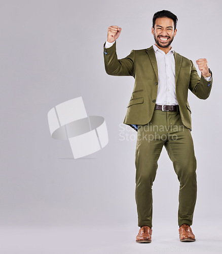 Image of Business man, portrait and happy about win, champion and success, cheers on studio background. Yes, fist pump and mockup space with young male, professional achievement and promotion, bonus or reward