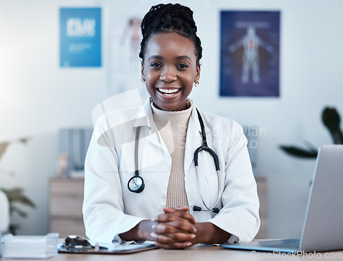 Image of Black woman, doctor in portrait and healthcare, smile in office and laptop, medical professional and happy in career. Female physician, hands and health mindset with cardiologist at clinic and leader