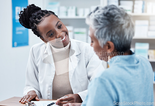 Image of Pharmacy, healthcare or medical with a customer and black woman pharmacist in a dispensary. Medical, insurance and trust with a female medicine professional helping a patient in a drugstore