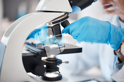 Image of Medical science, hands and microscope in a laboratory for research, analysis and study. Scientist person in lab for futuristic development, innovation and biotechnology with dna or bacteria particle