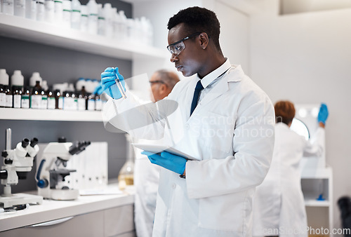 Image of Science, research and black man test tube and tablet for medical analysis and innovation in laboratory. Pharmaceutical analytics, medicine study and scientist in South Africa checking vaccine results