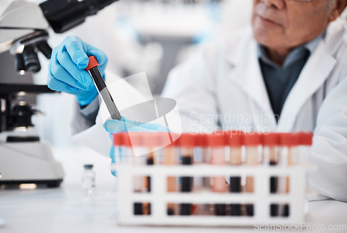 Image of Blood, science and scientist in laboratory with test tube sample for research, medical study and investigation. Healthcare, pharmaceutical and man with vial for dna testing, biology and rna analysis