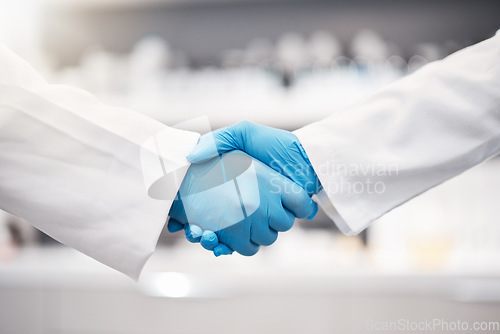 Image of Doctor, handshake and gloves for healthcare, partnership or trust for collaboration, unity or lab support at. Team of medical experts shaking hands in teamwork for agreement or research success