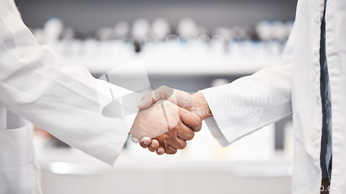 Image of Doctor, handshake and partnership in healthcare, medicine or trust for collaboration, unity or support at lab. Team of medical experts shaking hands in teamwork for agreement or success at pharmacy