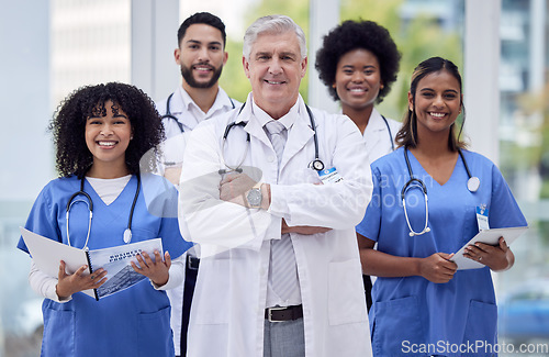 Image of Doctors, nurses and arms crossed portrait with leadership, tablet or paper results in diversity hospital, about us or support. Smile, happy or healthcare worker people in teamwork collaboration group