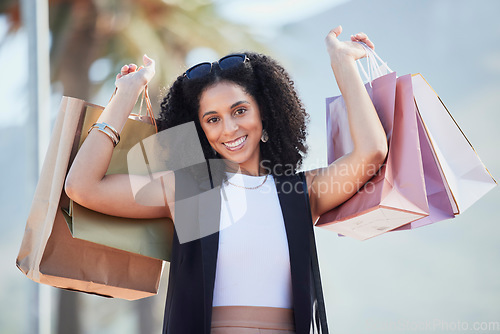 Image of Shopping, portrait and black woman with bags at a mall, happy and excited for sale. Face, fashion and girl with relax with luxury, purchase while walking outdoors, satisfied and cheerful on weekend