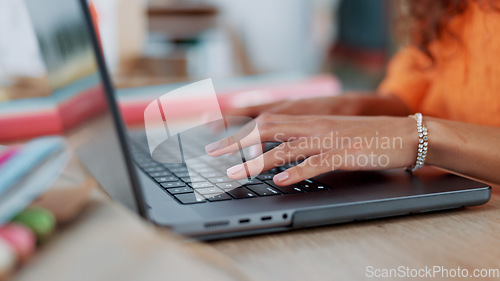 Image of Hands, typing and laptop with a black woman designer working in her office on a report or online order. Ecommerce, computer and creative with a young female freelance blogger at work on an article