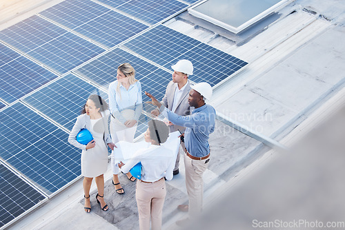 Image of Solar energy, teamwork or engineering team on roof by future electricity technology innovation together. Collaboration, top or black man talking or planning a grid sustainability project with people