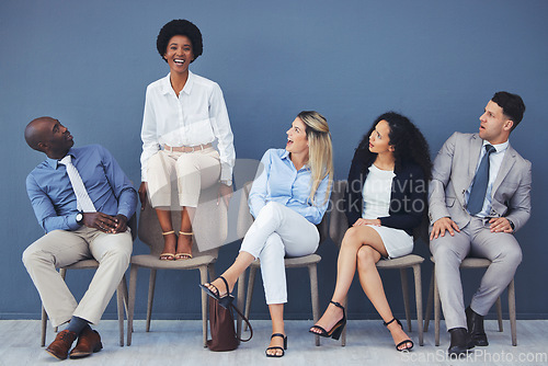 Image of Business people, hiring and waiting room of woman standing out against wall for interview, meeting or opportunity. Group of diverse interns looking at African American female candidate in recruitment