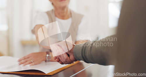 Image of Elderly business people, handshake and b2b for partnership, trust or deal agreement at the office table. Senior woman and man shaking hands for business meeting, interview or welcome at the workplace